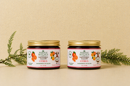 Two citrus balm jars with gold lids and matching orange label