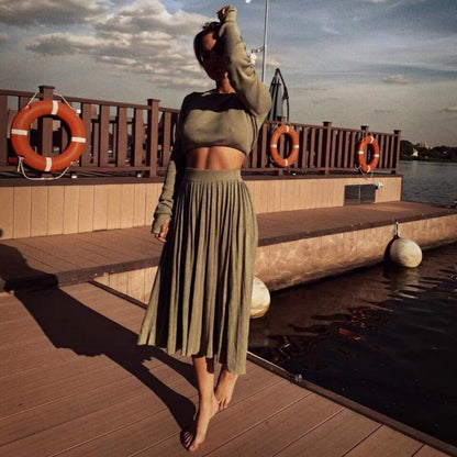 Olive long-sleeve knit crop top and pleated high-slit midi skirt