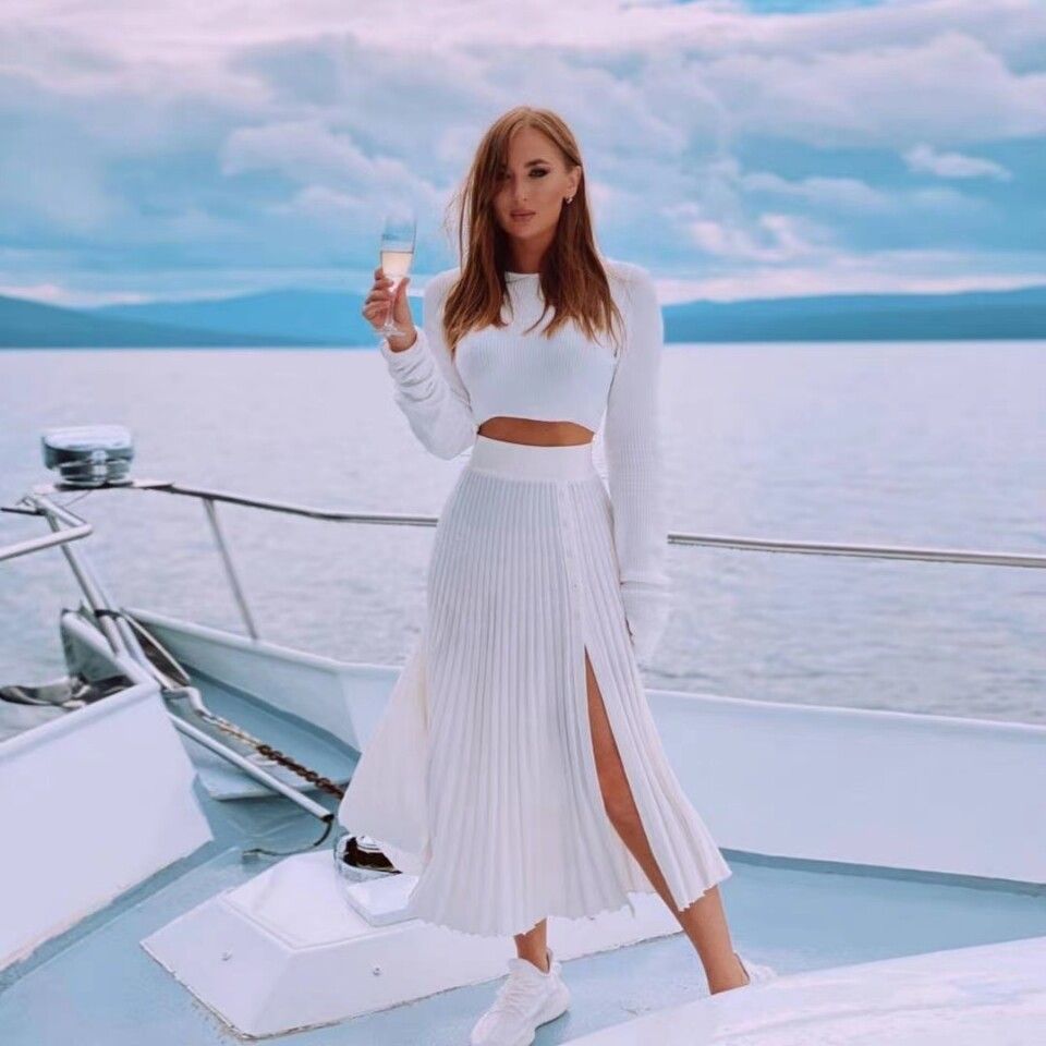 Ivory knitted two-piece: long-sleeve crop top and pleated skirt with front slit