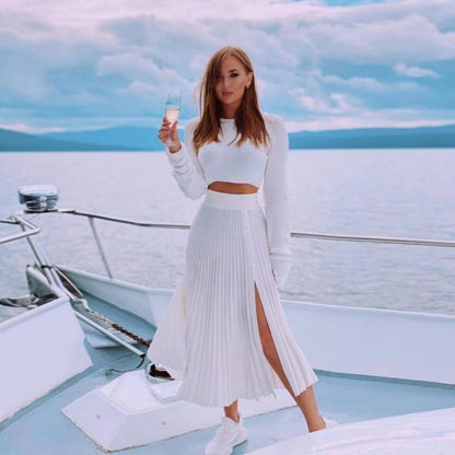Ivory knitted two-piece: long-sleeve crop top and pleated skirt with front slit