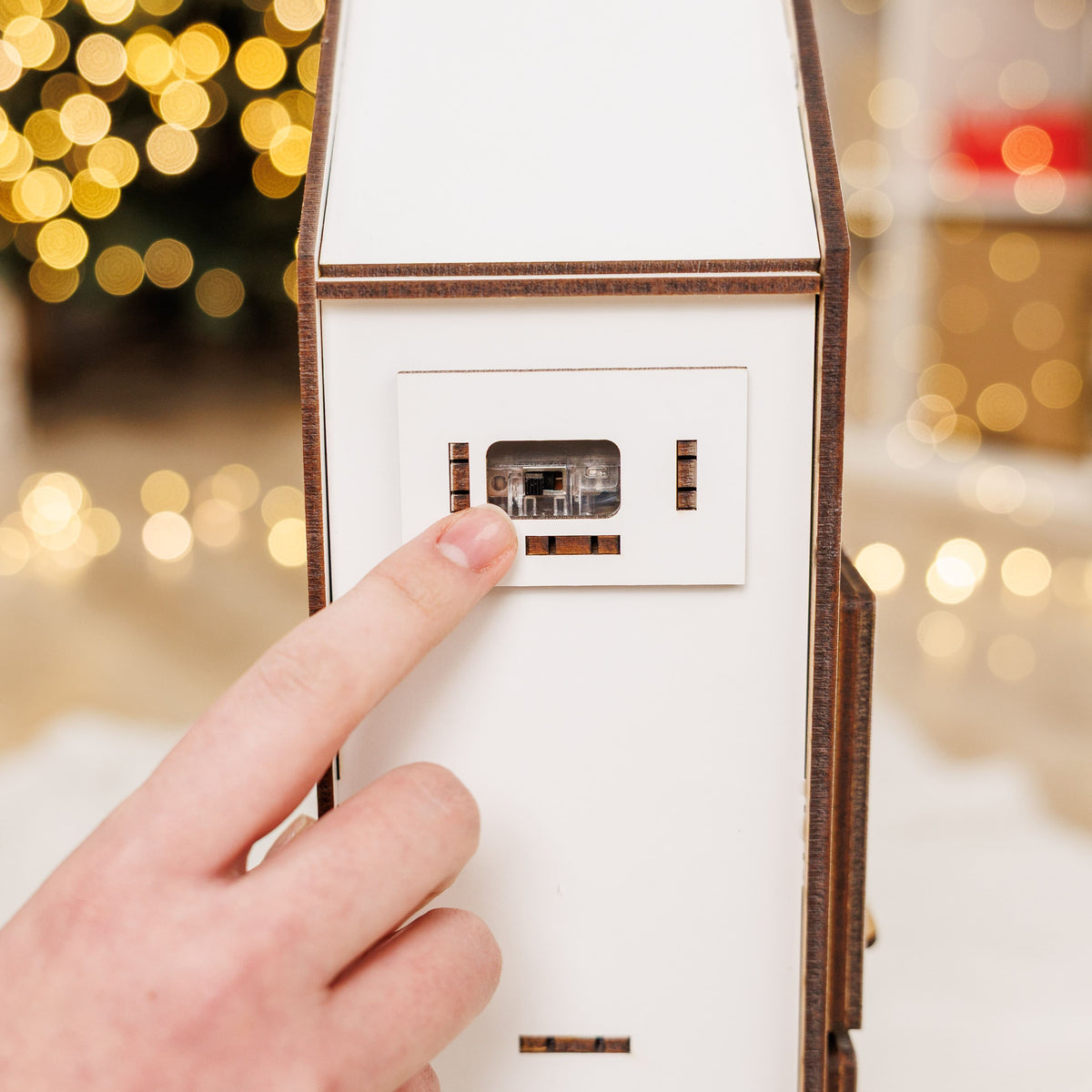 White advent calendar side panel with battery compartment and small electronic switch