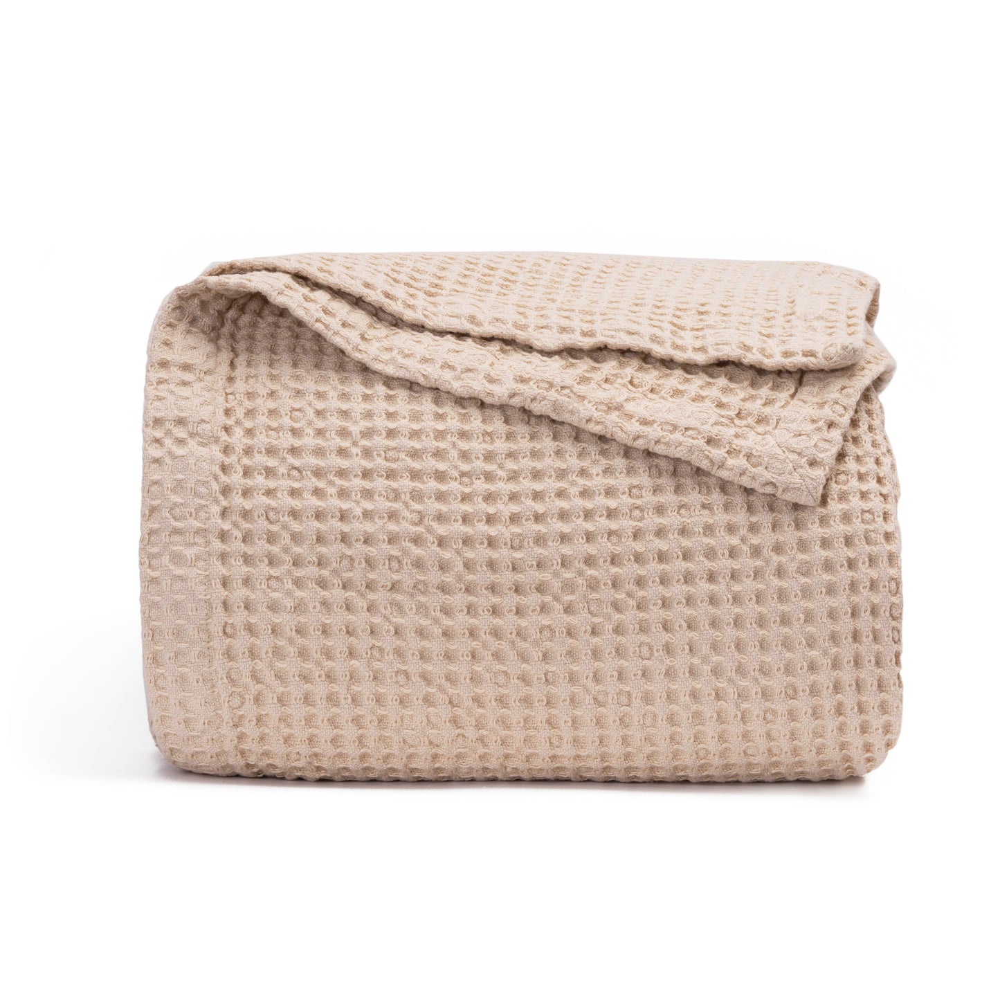 Waffle-weave blanket, folded, light beige with textured waffle pattern.
