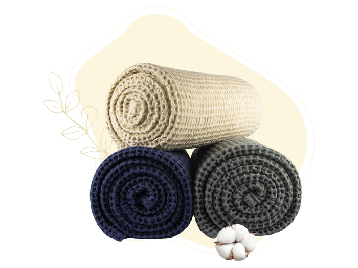 Waffle weave throw set with rolled blankets in cream, navy, and dark gray.