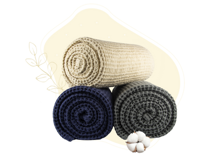 Waffle weave throw set with rolled blankets in cream, navy, and dark gray.