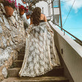 White crochet beach cover-up dress with openwork lace fabric.