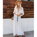 White crochet beach cover-up dress with lace pattern and long sleeves.