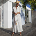 White crochet beach cover-up dress with V-neck and long wide hem.
