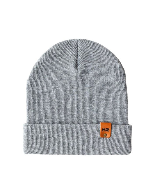 Gray knit beanie with folded cuff and small orange logo patch on the front.