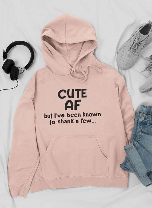 Light pink hoodie with front “CUTE AF” text, kangaroo pocket, drawstring hood.