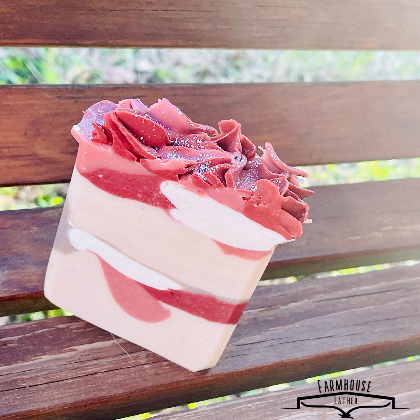 Layered soap bar with pink ridged top and white stripe layers