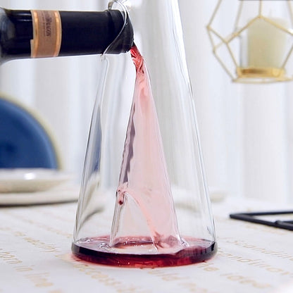 Transparent wine decanter close-up, red wine pouring into the clear cone base