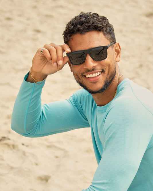 Black polarized sunglasses worn on a man, dark lenses visible.