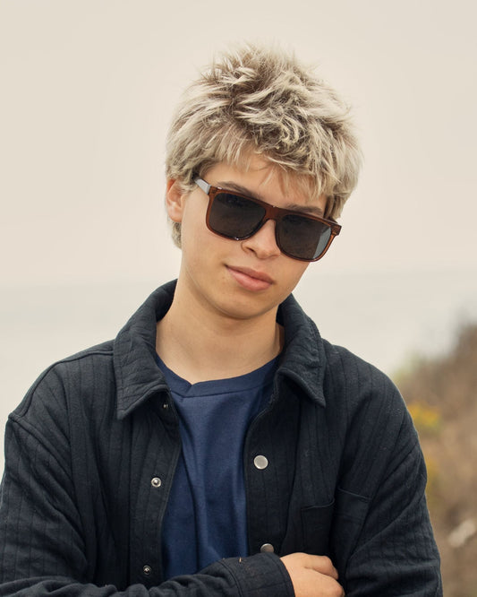 Polarized sunglasses with dark lenses and brown frames on a person