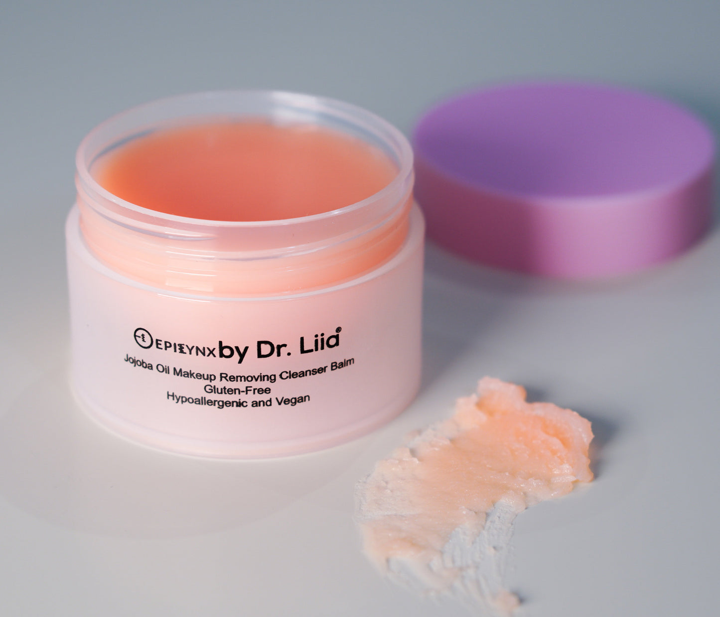 Peach makeup remover cleansing balm jar with open lid and balm scoop
