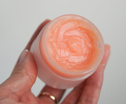 Apricot makeup remover balm in a clear jar with visible creamy swirl