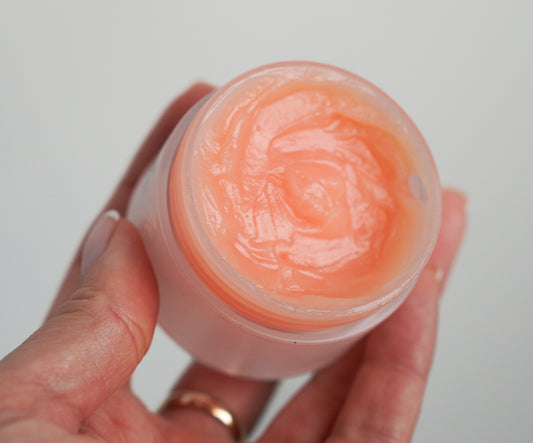 Apricot makeup remover balm in a clear jar with visible creamy swirl