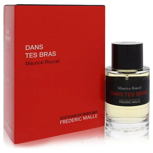 Unisex fragrance bottle beside red box; clear glass with black cap