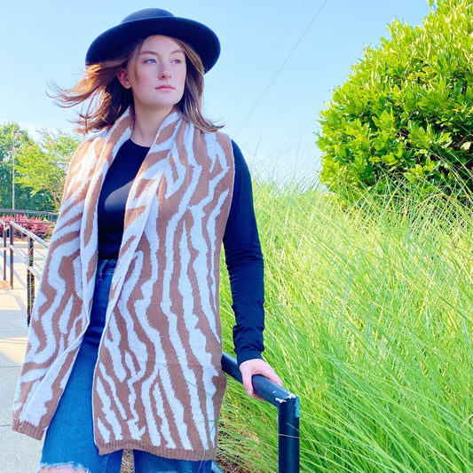 Zebra-pattern knit scarf in tan and white with long fringed ends