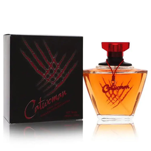 Perfume bottle with orange glass and red spray top, next to black product box