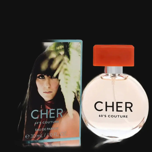 Women's perfume set with round glass bottle, orange cap, and Cher 60's Couture box