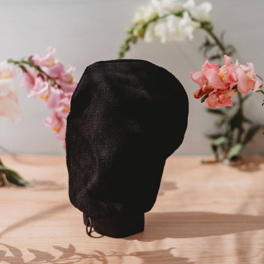 Exfoliating mitt glove, dark black fabric with wrist drawstring