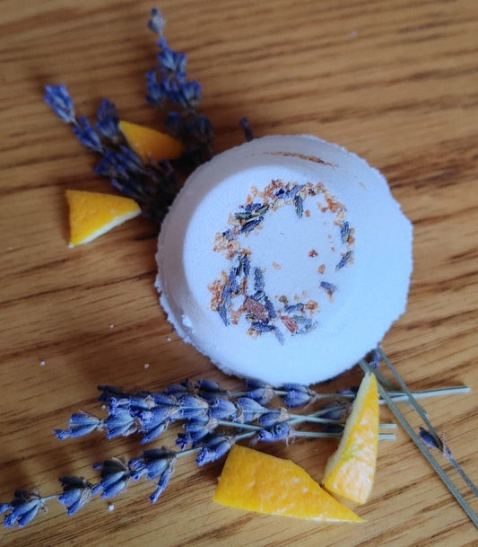Shower steamer disc with dried blue flowers and orange wedges
