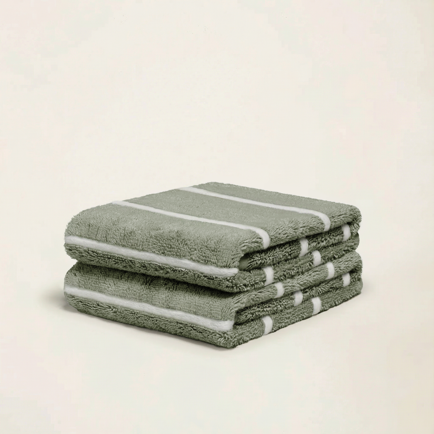 Sage green cotton towels set, folded stack with white stripe trim