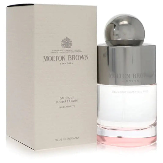Molton Brown perfume bottle with silver dome cap and pink base liquid beside beige product box