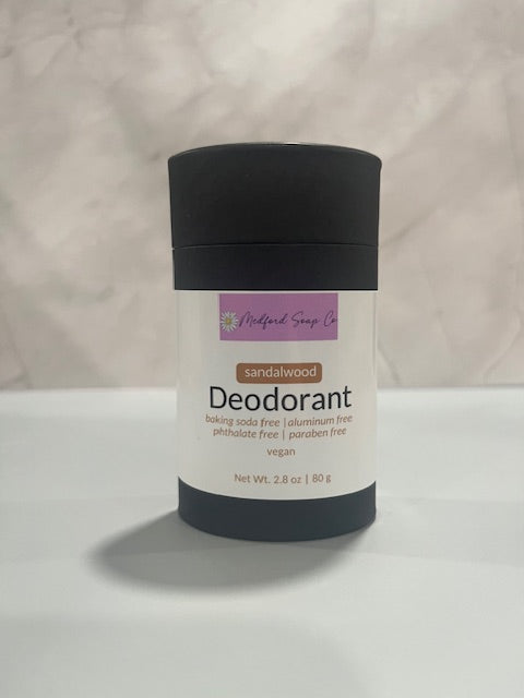 Deodorant stick with black cap, white label, sandalwood scent