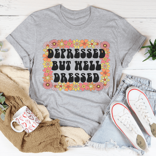 Heather gray graphic T-shirt with floral "Depressed But Well Dressed" lettering