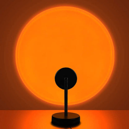 Sunset lamp with orange circular glow and black base with upright connector