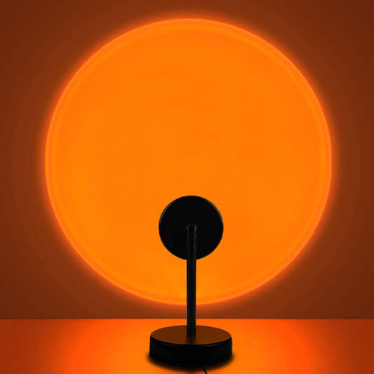 Sunset lamp with orange circular glow and black base with upright connector