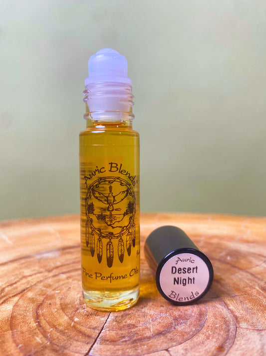 Roll-on perfume oil bottle with amber liquid and light purple cap, plus round lid