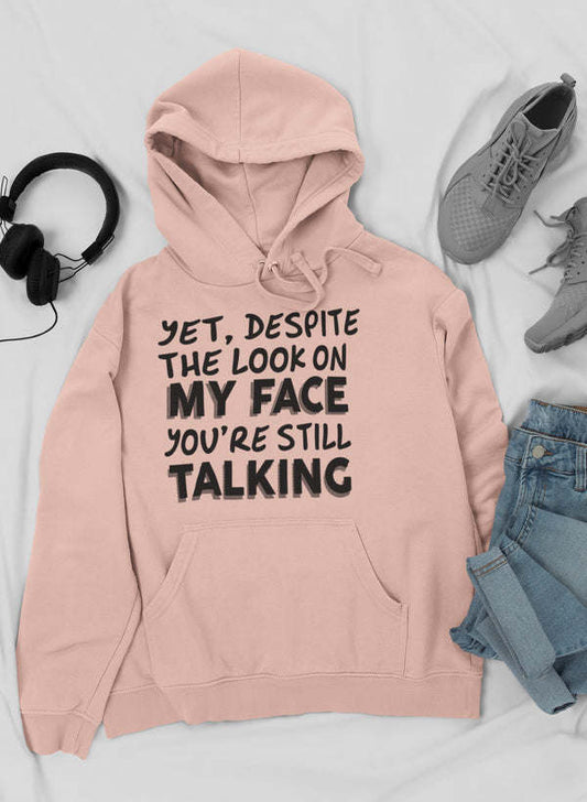 Heather peach pullover hoodie with hood, drawstring, front pocket and bold text graphic.