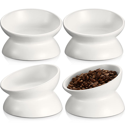 White ceramic elevated cat bowls set of 4, tilted design; one bowl holds kibble.