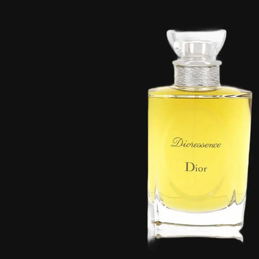 Women’s perfume bottle with gold cap; yellow glass with Dioressence label