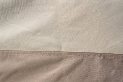 Close-up of light beige/cream woven cover fabric with textured surface.