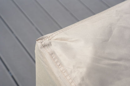 Corner of light beige/cream patio sofa cover with stitched seam detail.