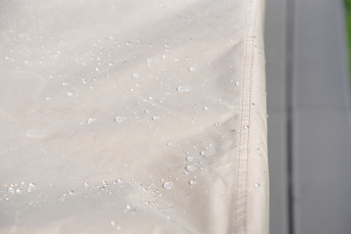 Water-resistant patio sofa cover fabric with water droplets, beige