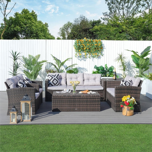Dark brown wicker conversation set with cushions and storage table