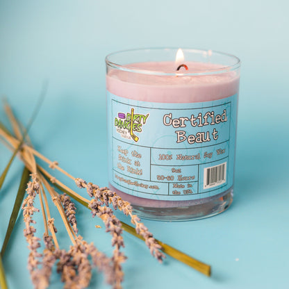 Hockey candle in clear jar with pink wax, “Certified Beaut” label