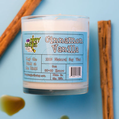 Hockey candle in clear jar with white wax, “Cinnamon Vanilla” label