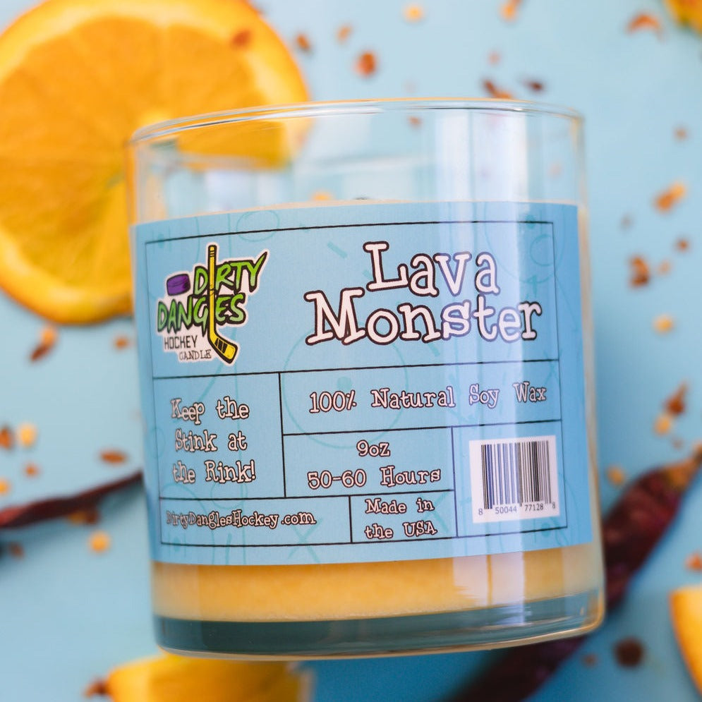 Hockey candle in clear jar with orange wax, “Lava Monster” label