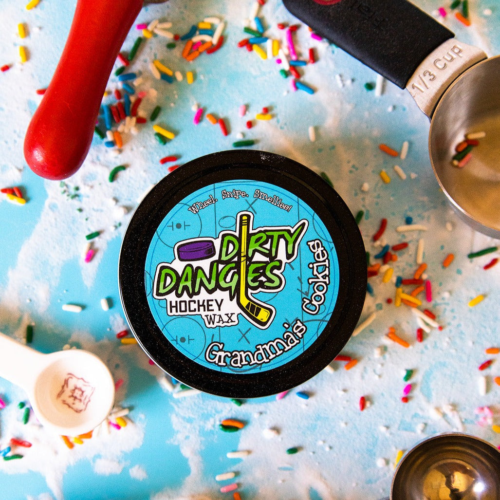 Round hockey wax tin with dark wax and black lid with Dirty Dangles graphic