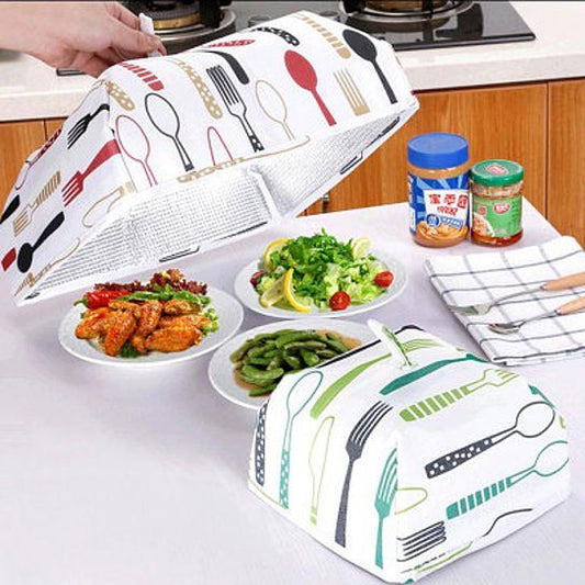 Insulated foldable food cover tent raised over food, white fabric with utensil print