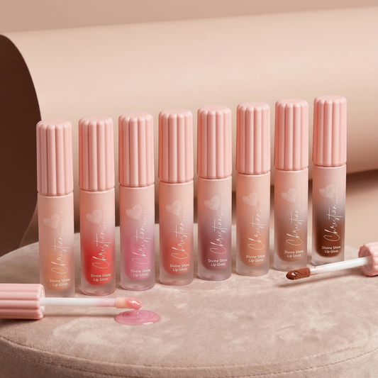 Divine Shine lip gloss tubes in pastel pink, with ribbed caps and wand applicators