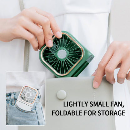 Mini cooling foldable fan in green clipped to a pocket