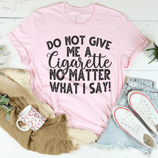 Pink short-sleeve crewneck T-shirt with bold slogan graphic text on front.