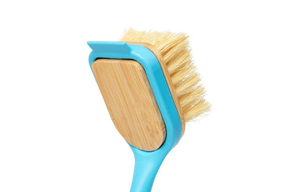 Dish brush with blue frame and tan wooden insert, tipped with light yellow bristles