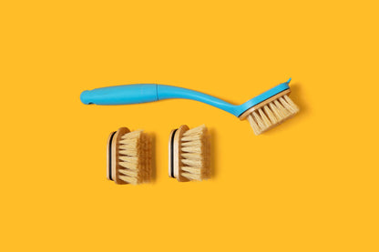 Blue dish brush and two replacement brush heads with tan centers and light bristles